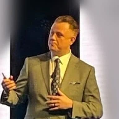 Carl Prieto presenting on stage